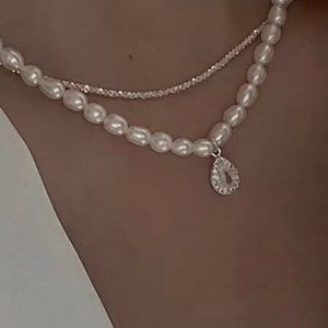 A shimmering layered necklace with AAA CZ oval natural freshwater pearl